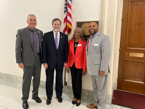Group photo from left to right of Jon Katz, Congressman Norcross, Arlene Still, and Maurice Tyndell