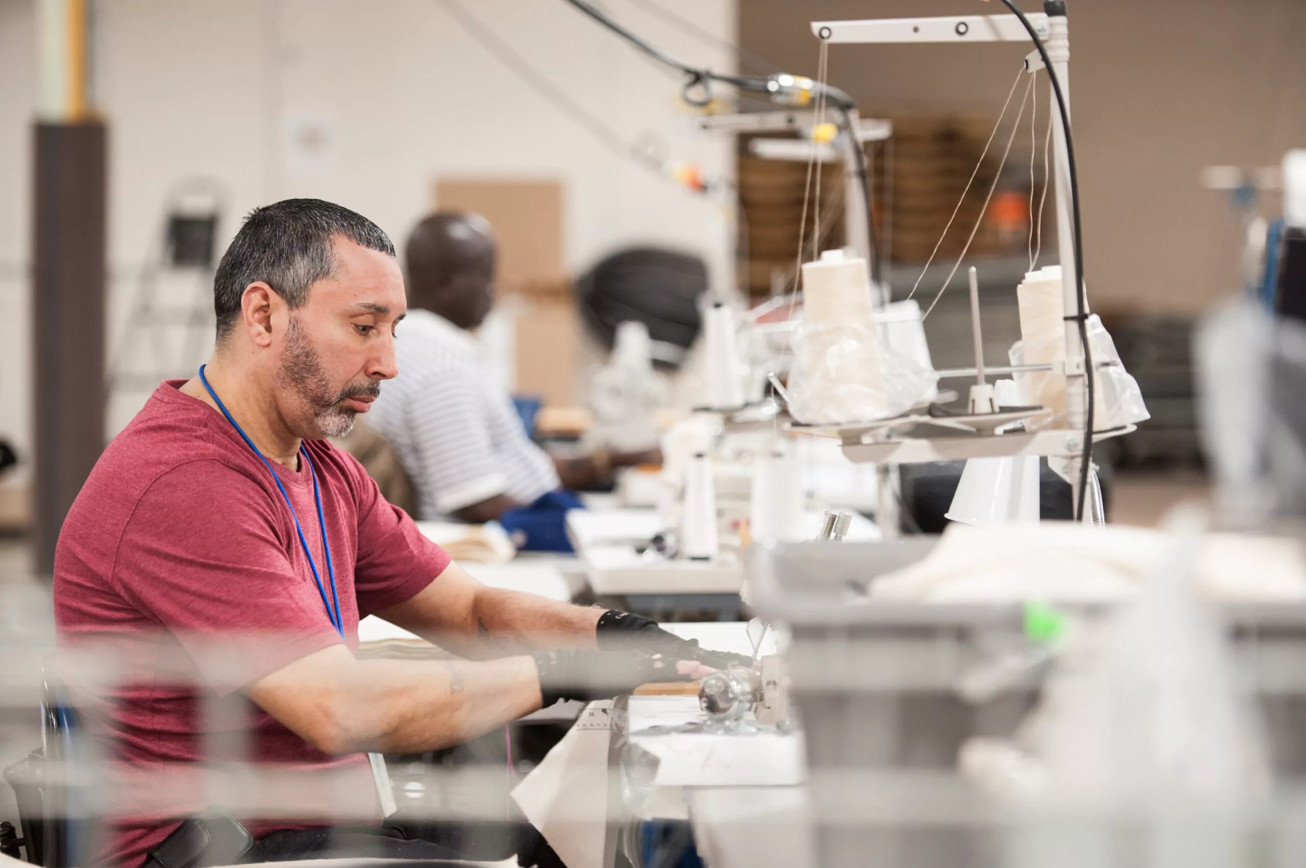 Man operating a sewing machine